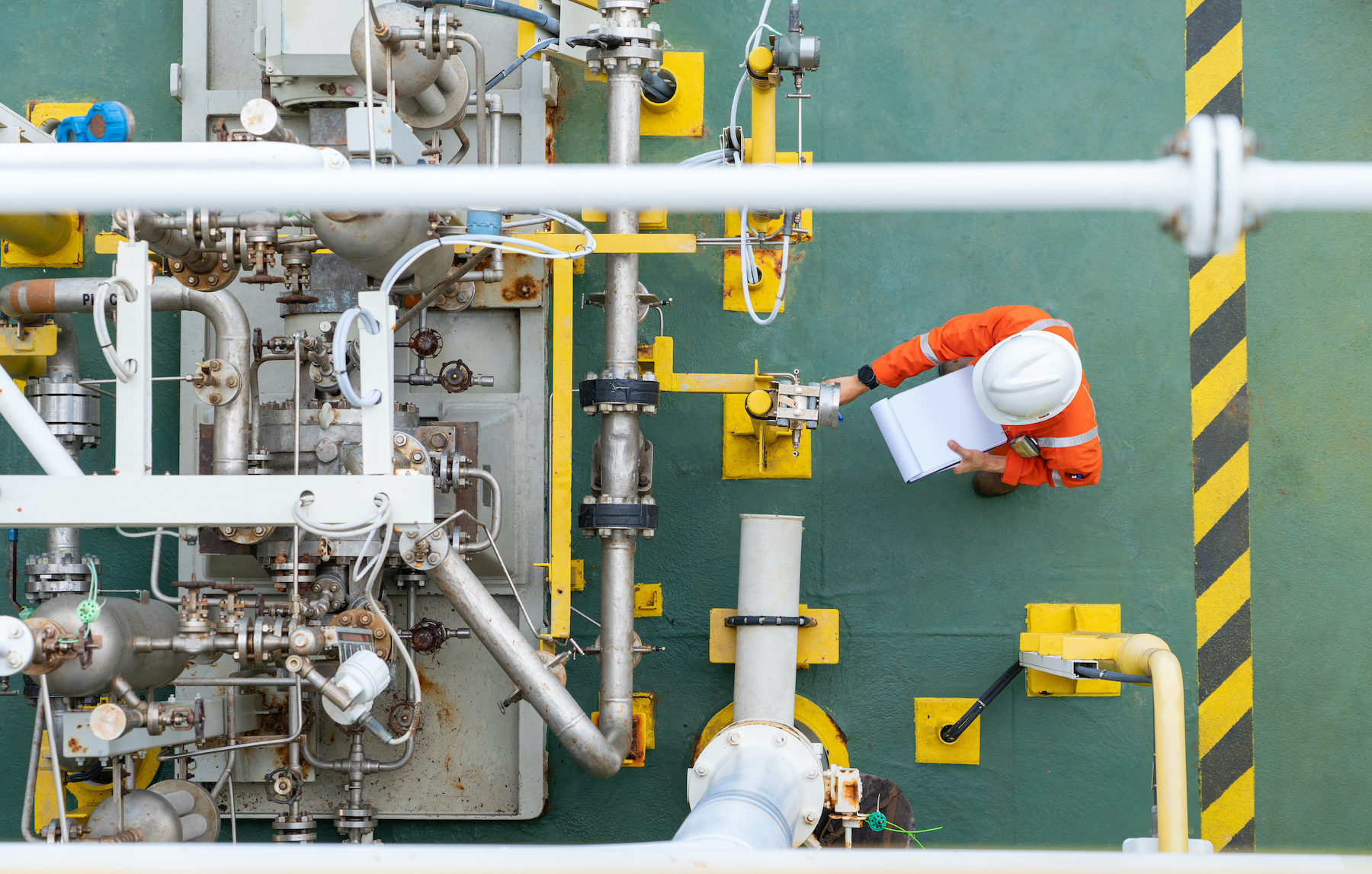 Mechanical operator checking centrifugal pump condition for daily checking oil pump system to maintain reliability of oil and gas production process.