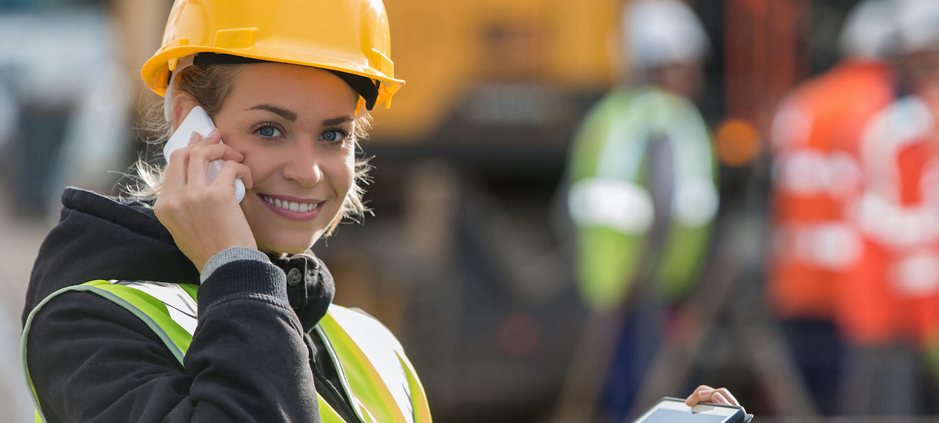 panoramic view of young female architect with construction team