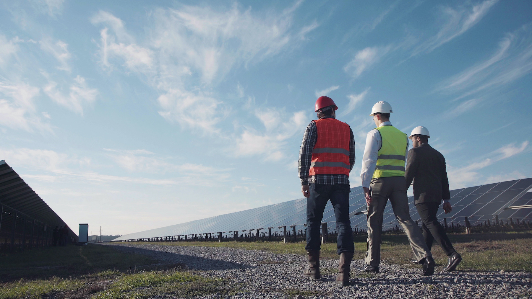 Technician walks with workman and investor