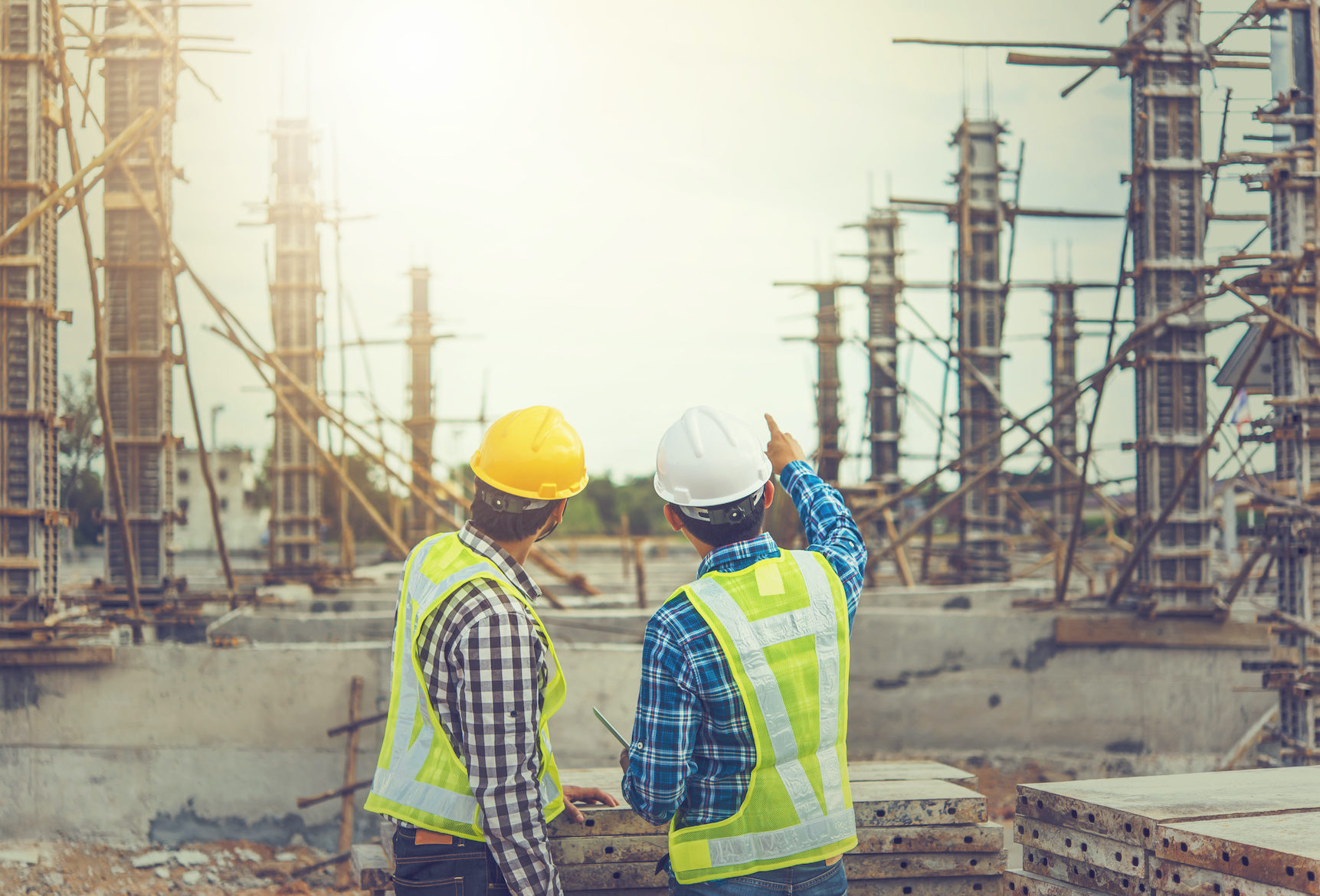 Two young man architect on a building construction site