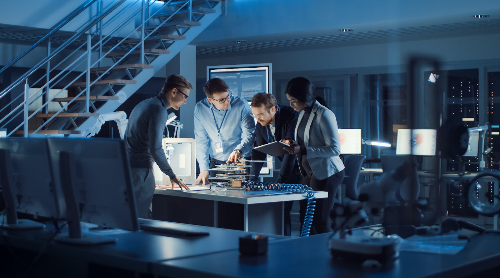 Engineers working around table to finish a project