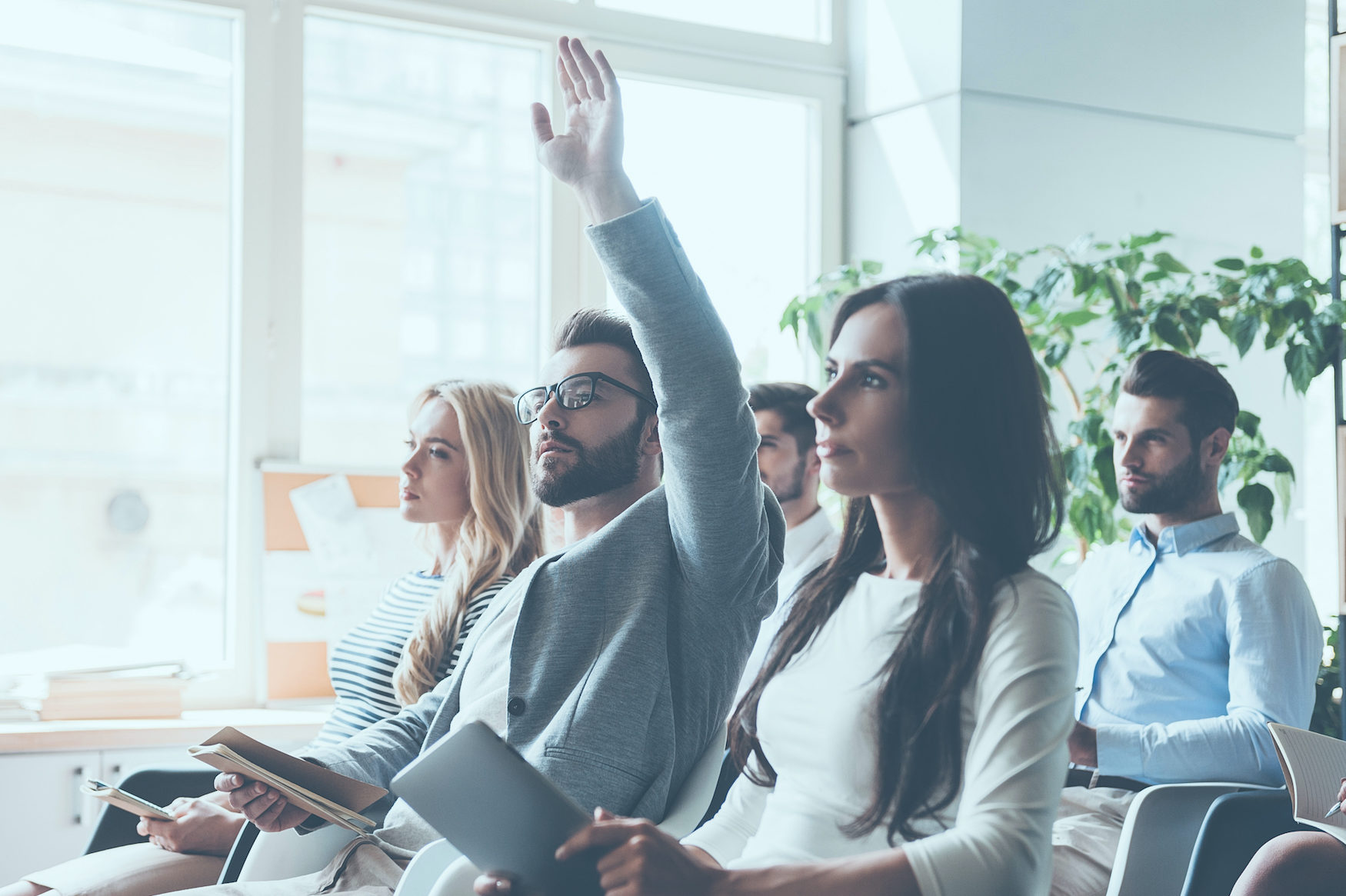 Group of engineers asking questions during a meeting