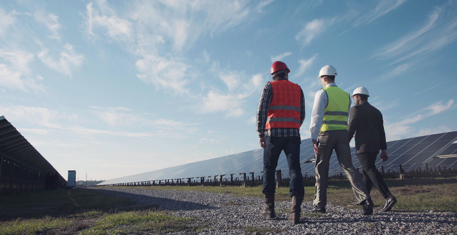 Technician walks with workman and investor