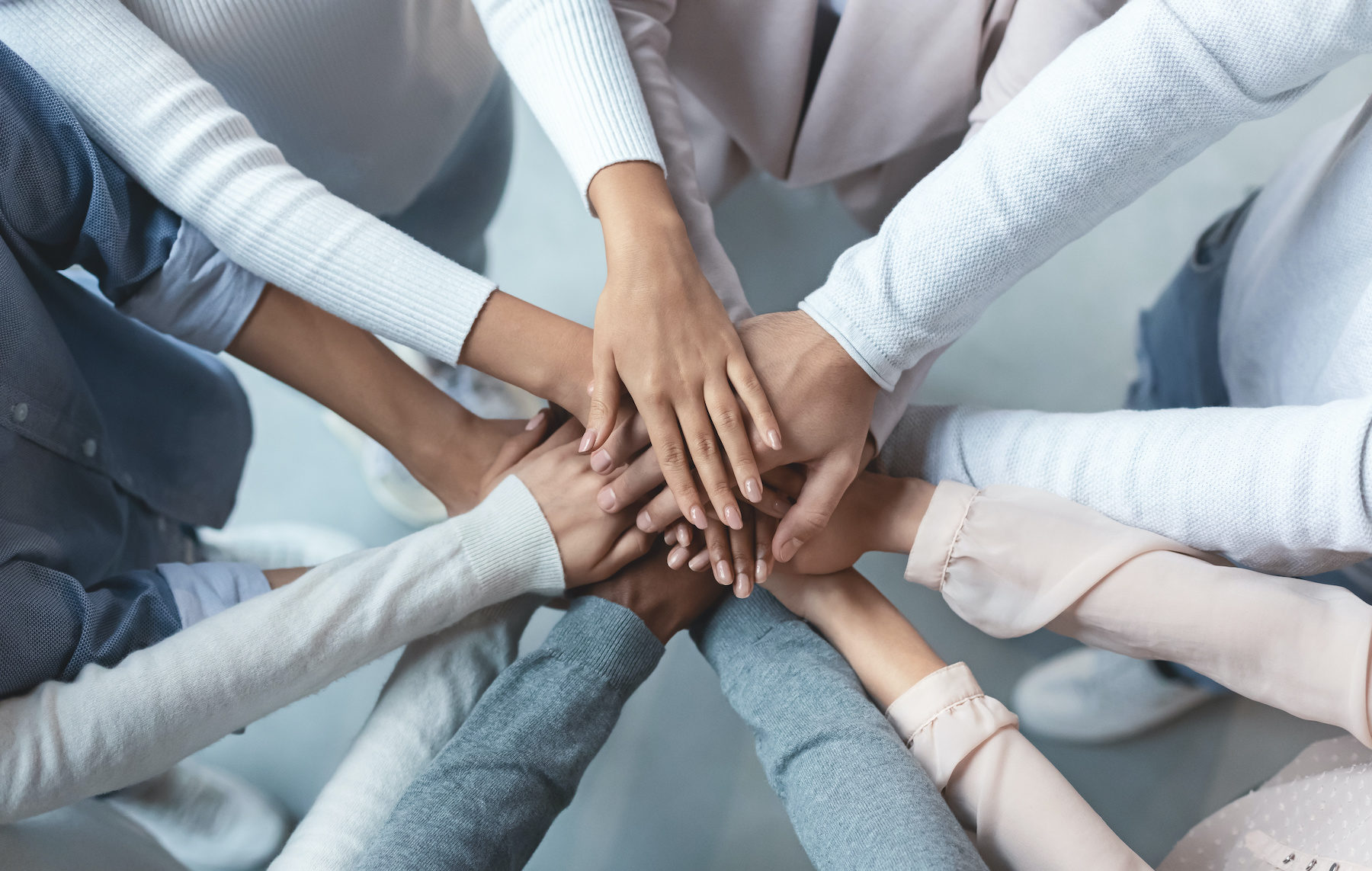 Business team putting hands on top of each other