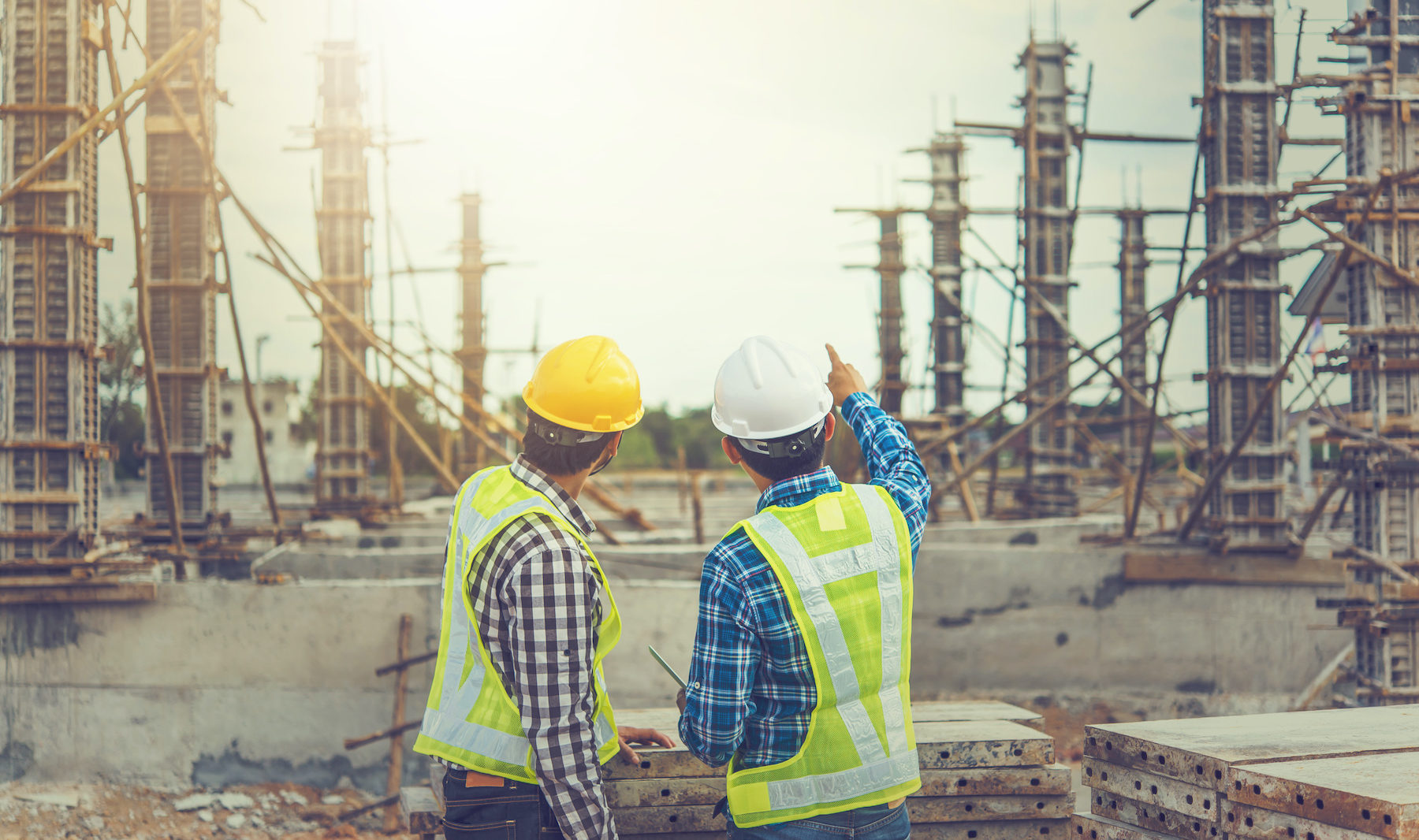 Two young man architect on a building construction site