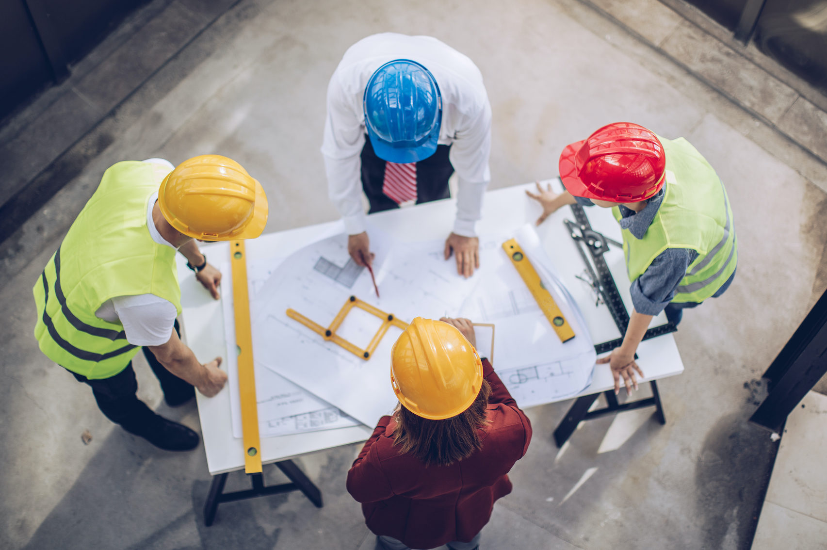 Construction workers and architects working on construction site