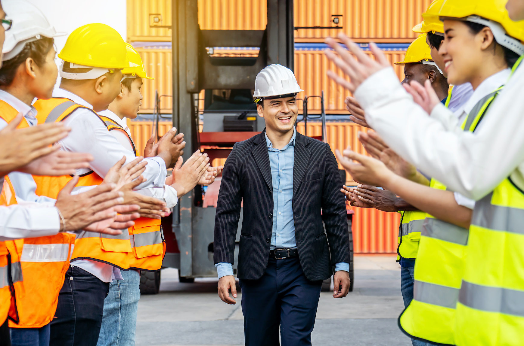 Professional Engineering and worker team congratulated success by applaud their jubilant leader after construction project complete with success. Engineering heavy industry concept